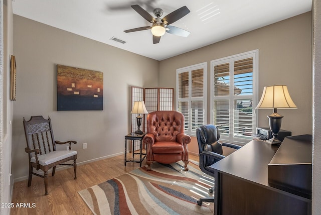 office with ceiling fan and light wood-type flooring