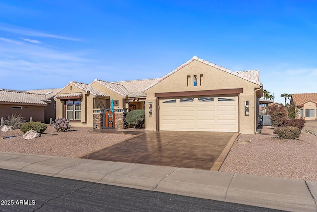 view of front of home with central AC and a garage