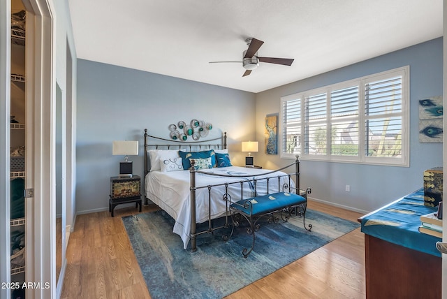 bedroom with hardwood / wood-style flooring and ceiling fan