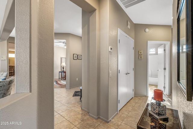 corridor featuring light tile patterned flooring