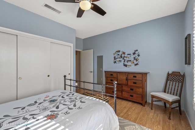 bedroom featuring light hardwood / wood-style floors, a closet, and ceiling fan