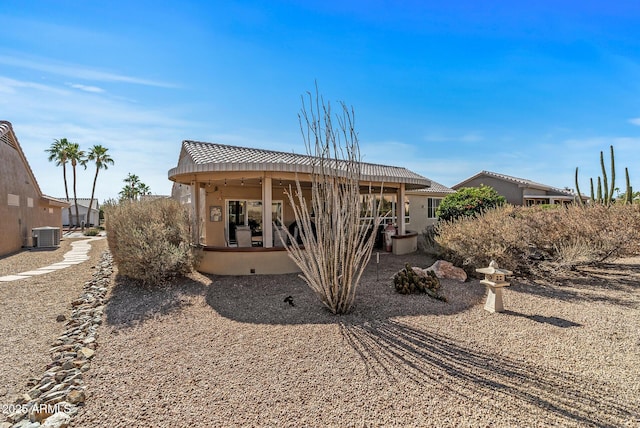 back of property featuring central AC and a patio area