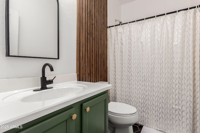 bathroom featuring toilet, curtained shower, tile patterned flooring, and vanity