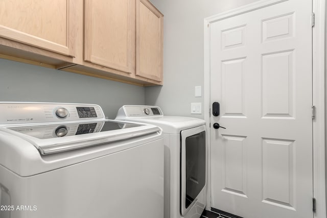 washroom featuring cabinet space and washing machine and clothes dryer