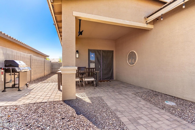 view of patio with grilling area and fence