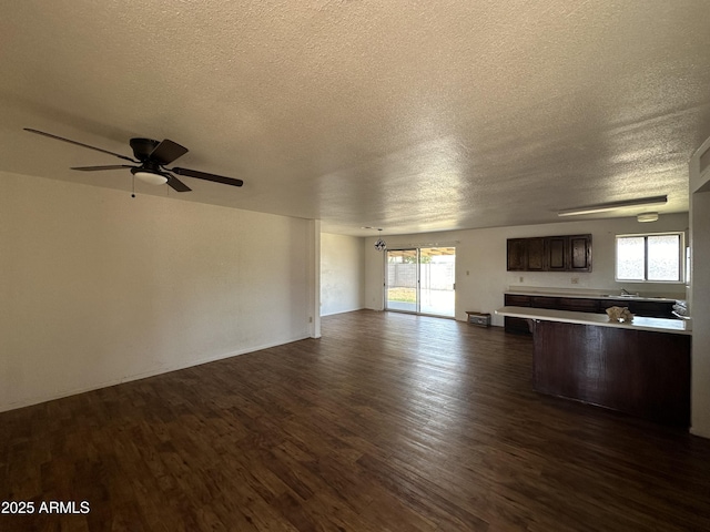 8944 N 17th Ln, Phoenix, AZ 85021 - unfurnished living room with dark wood-type flooring, ceiling fan, a sink, and a textured ceiling