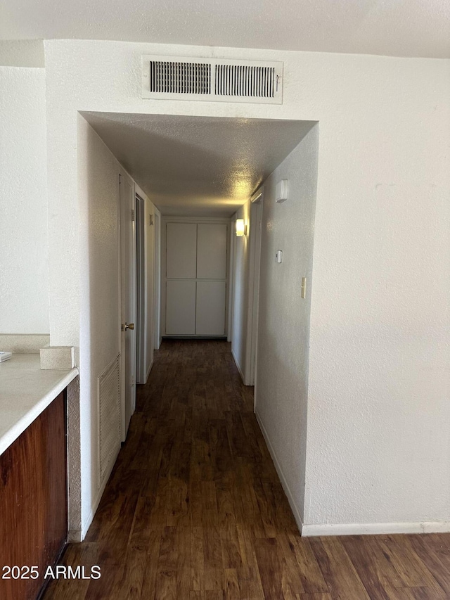 8944 N 17th Ln, Phoenix, AZ 85021 - hall with dark wood-style flooring, baseboards, and visible vents