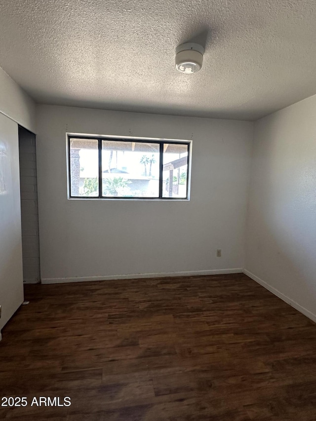 8944 N 17th Ln, Phoenix, AZ 85021 - empty room featuring a textured ceiling, wood finished floors, and a healthy amount of sunlight