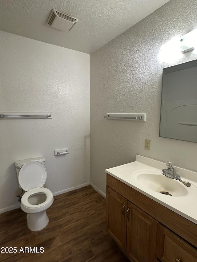 8944 N 17th Ln, Phoenix, AZ 85021 - bathroom with visible vents, baseboards, toilet, vanity, and wood finished floors