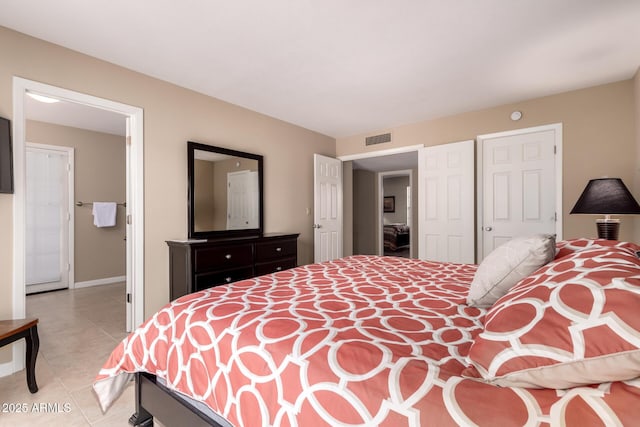 bedroom with visible vents, baseboards, and light tile patterned floors