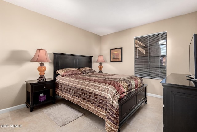 bedroom featuring light tile patterned floors and baseboards