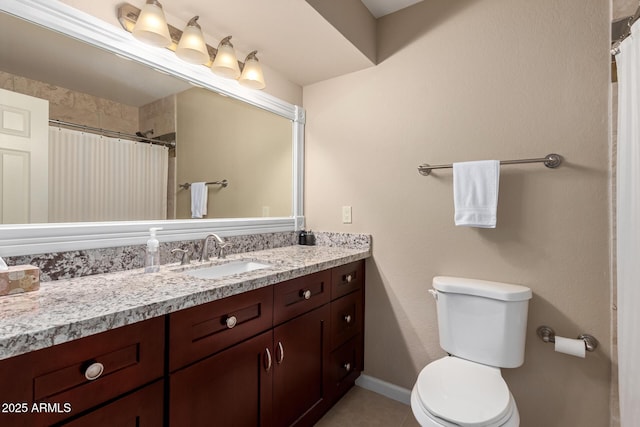 bathroom featuring a shower with shower curtain, toilet, vanity, baseboards, and tile patterned floors