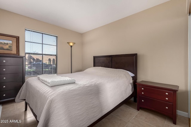 bedroom featuring light tile patterned flooring