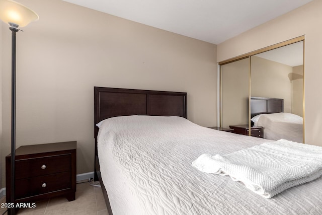 bedroom featuring tile patterned flooring and a closet