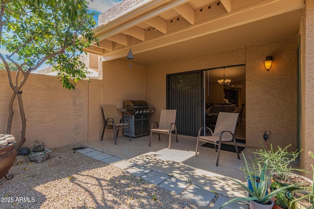 view of patio / terrace featuring a grill and fence