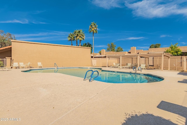 pool featuring a patio and fence