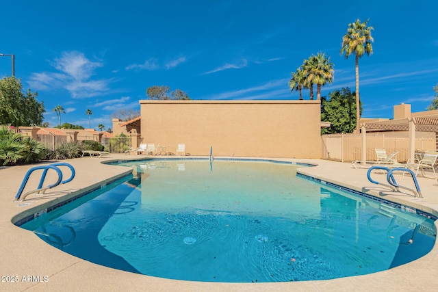 pool with fence and a patio