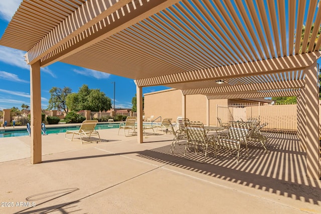 view of patio with fence, a community pool, and a pergola