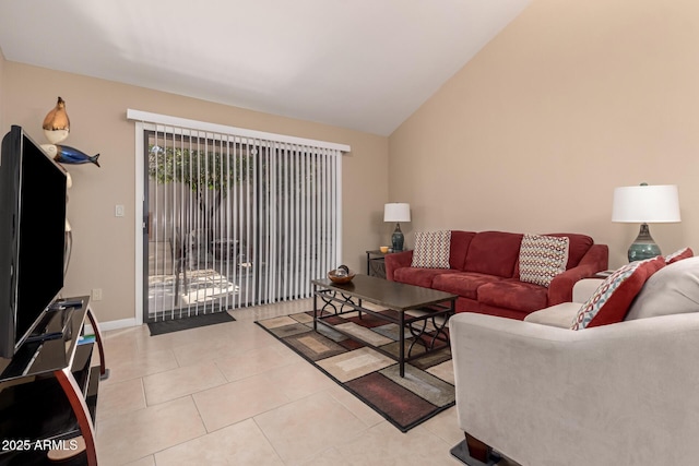 living area with vaulted ceiling, light tile patterned floors, and baseboards