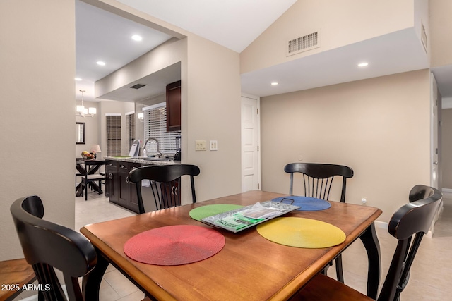 dining room with vaulted ceiling, a chandelier, visible vents, and recessed lighting