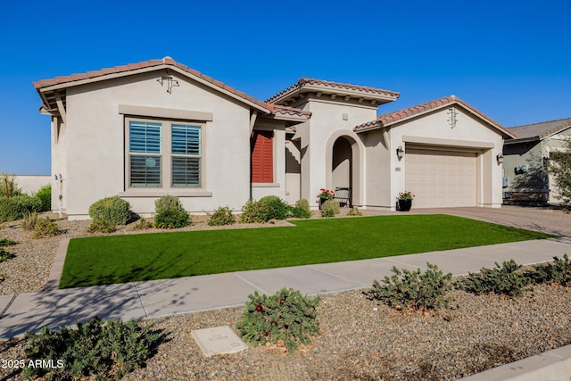 mediterranean / spanish home featuring a front lawn, a tile roof, stucco siding, driveway, and an attached garage