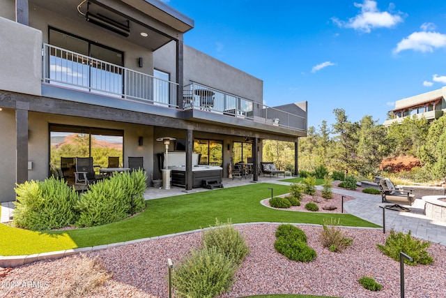 view of property's community with a yard, an outdoor living space, and a patio