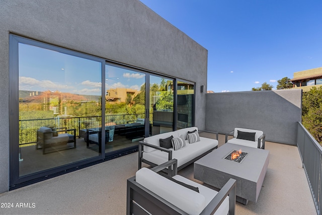 view of patio / terrace with an outdoor living space with a fire pit