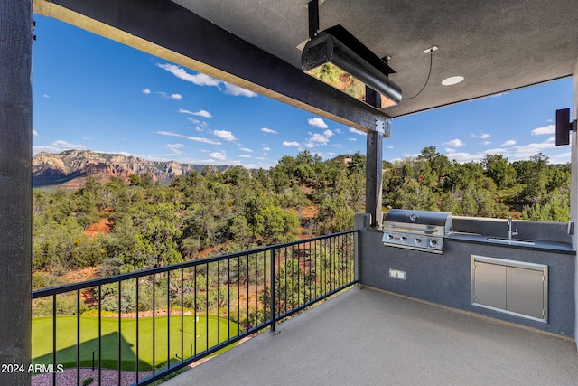 balcony featuring grilling area, a mountain view, and sink