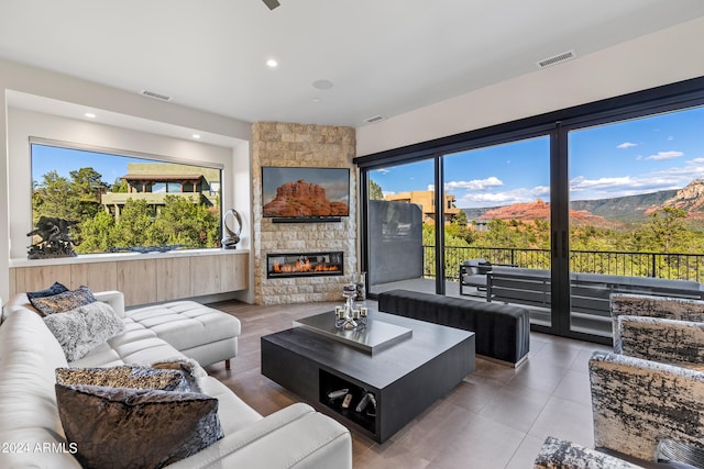 living room with a fireplace and tile patterned flooring