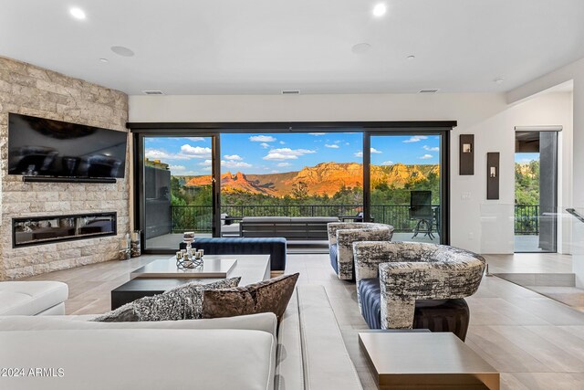 living room with light tile patterned floors, a fireplace, and a mountain view