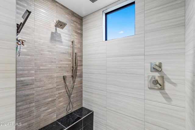 bathroom with a tile shower