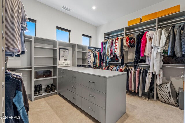 spacious closet featuring light carpet