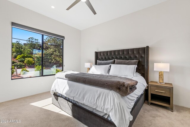 bedroom with ceiling fan and light carpet