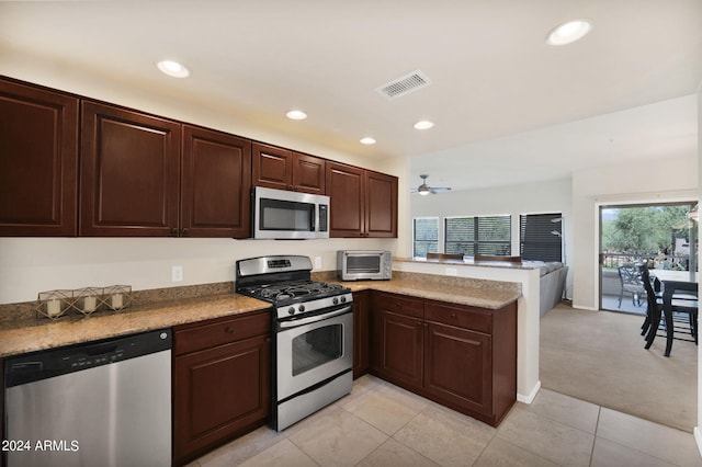 kitchen featuring visible vents, recessed lighting, appliances with stainless steel finishes, a peninsula, and a toaster