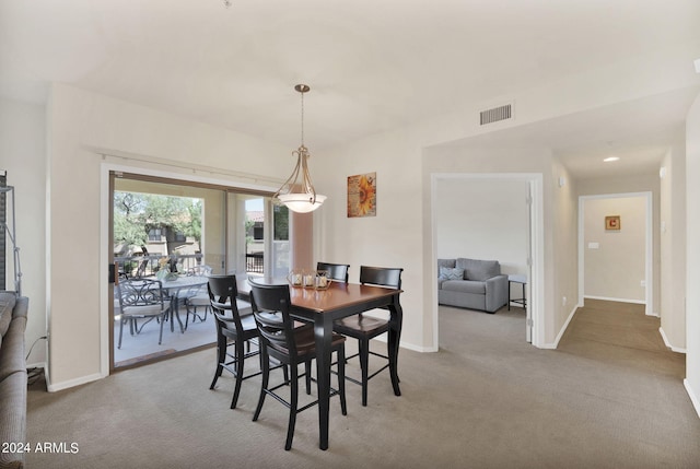 carpeted dining room featuring baseboards, visible vents, and french doors