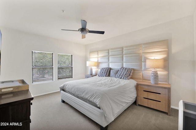 carpeted bedroom featuring heating unit, baseboards, and ceiling fan