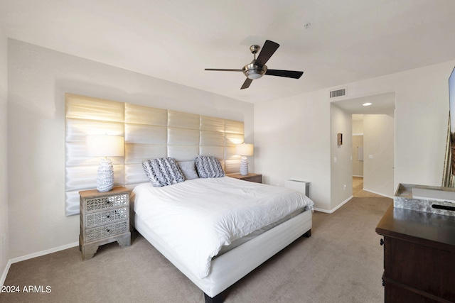 bedroom with visible vents, baseboards, and light colored carpet