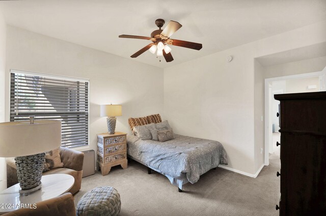 carpeted bedroom featuring ceiling fan and baseboards