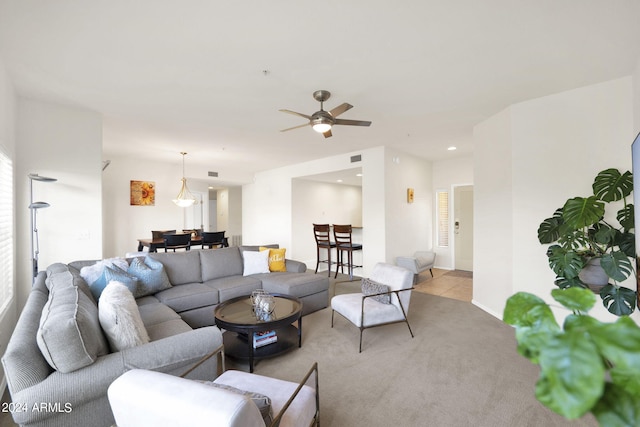 carpeted living room featuring tile patterned flooring, visible vents, baseboards, ceiling fan, and recessed lighting