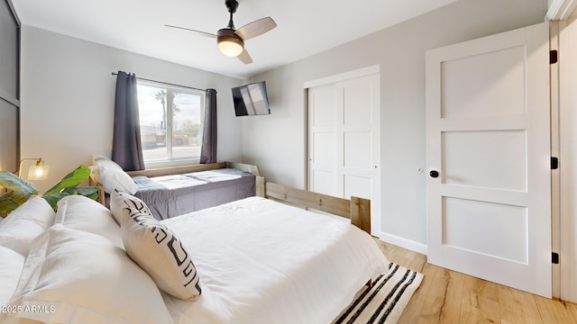 bedroom with ceiling fan, light wood-type flooring, and a closet