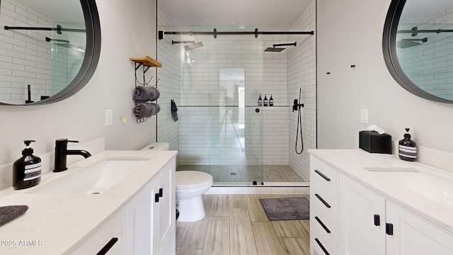 bathroom featuring vanity, toilet, and walk in shower