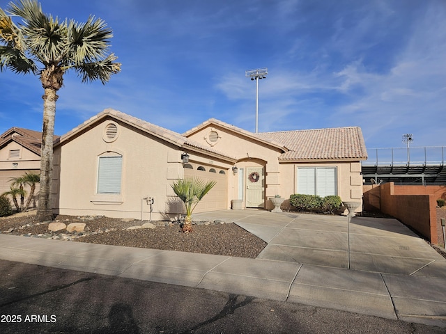 view of front of home with a garage and solar panels