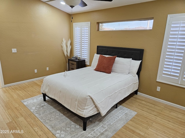 bedroom with wood-type flooring and ceiling fan