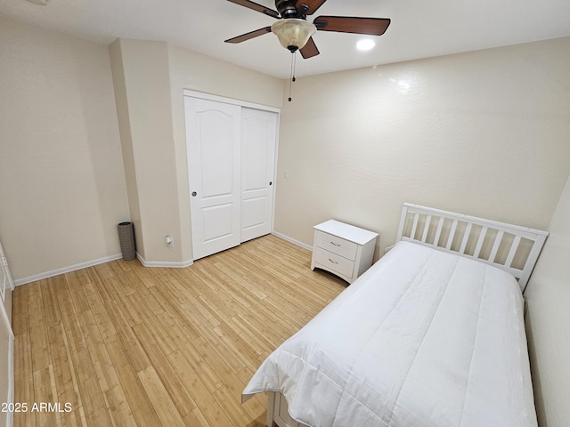 bedroom featuring hardwood / wood-style floors, a closet, and ceiling fan