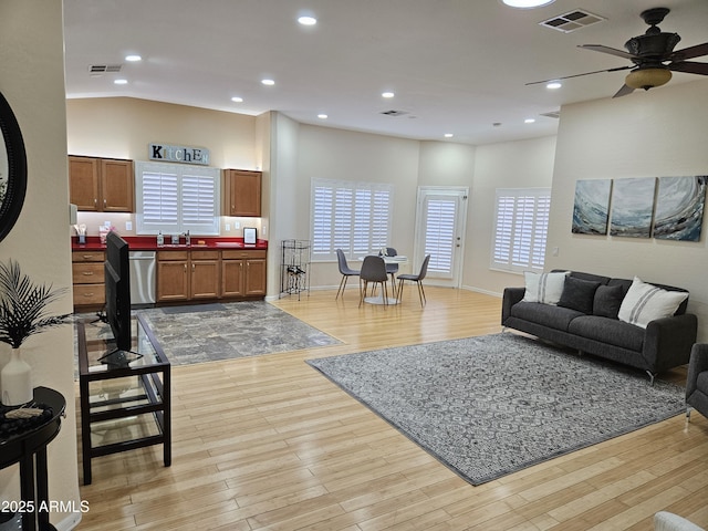 living room featuring ceiling fan and light wood-type flooring