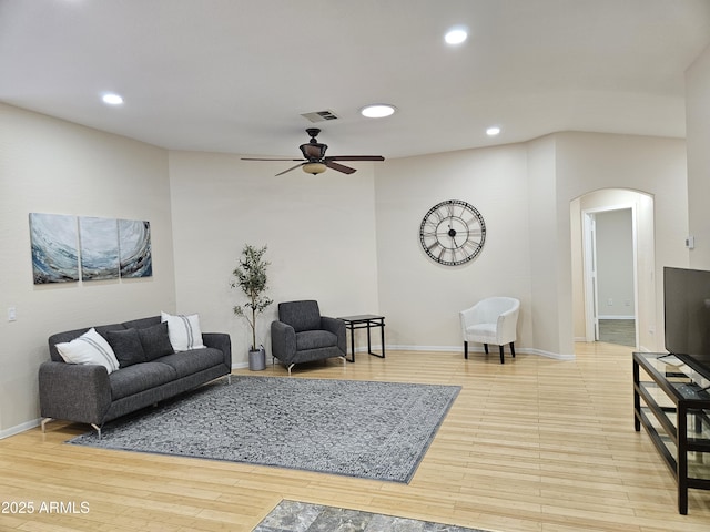 living room with ceiling fan and light hardwood / wood-style floors