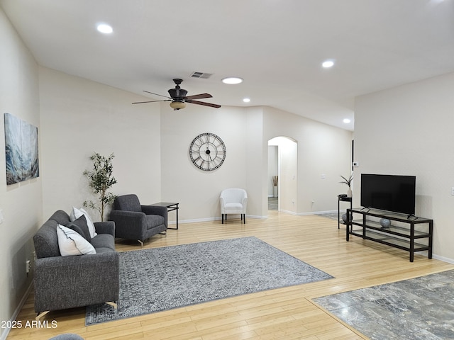 living room with ceiling fan and hardwood / wood-style floors