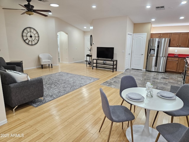 living room featuring ceiling fan and light hardwood / wood-style floors