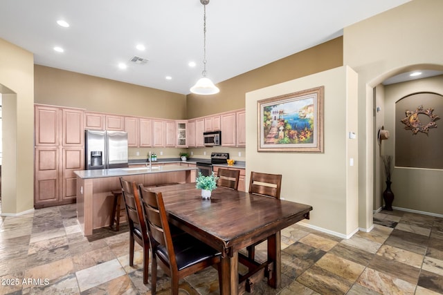 dining room featuring baseboards, recessed lighting, visible vents, and stone tile floors