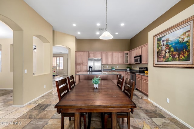 dining room featuring baseboards, stone tile flooring, and recessed lighting